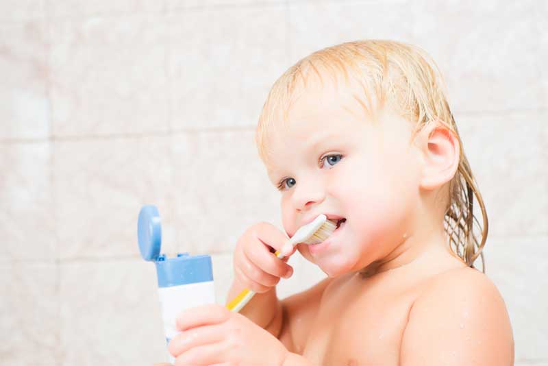 baby brushing his teeth